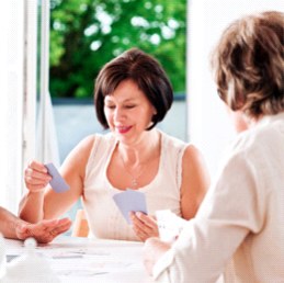 Caregiver and client playing cards